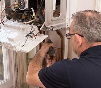 Central heating repair engineer while working