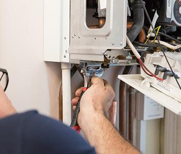 Gas engineer installing central heating in a London property