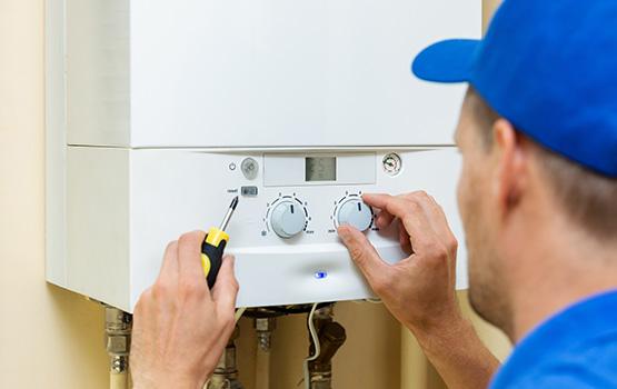 Get your gas boiler repaired by a certified heating engineer a man working on a gas boiler