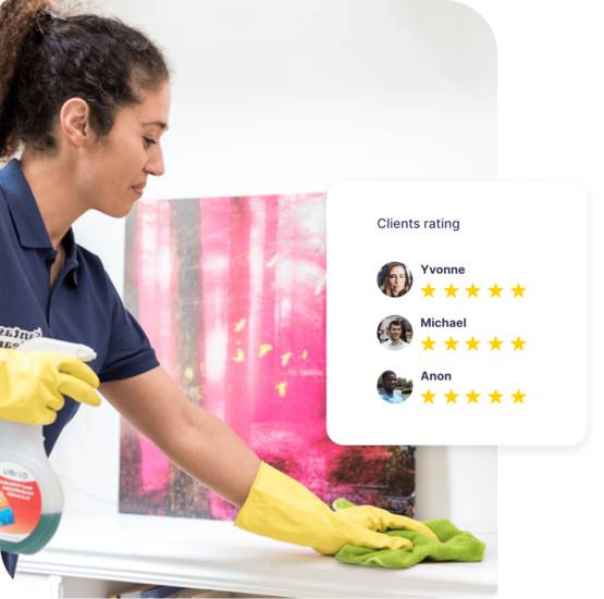 A woman in a Fantastic Services uniform cleans a table with a yellow glove, showcasing the excellent work of our cleaners Islington