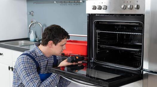 Technician repairs an oven